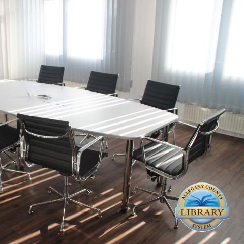 Board room with table and chairs, ACLS logo