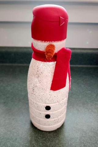 Photo of snowman made from a bottle of creamer.