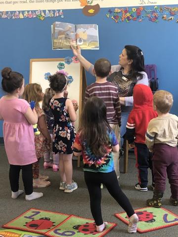 children enjoy story read by library staff