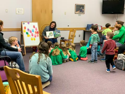 children enjoy story read by library staff