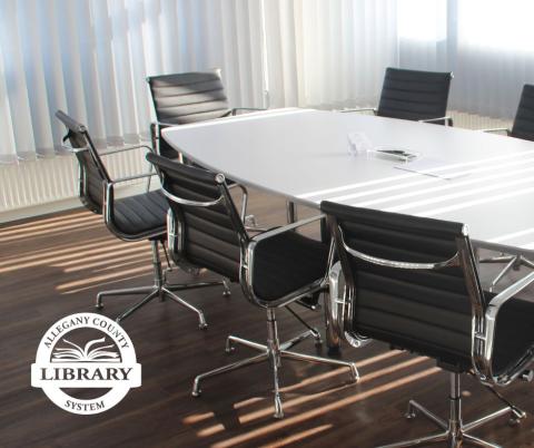 Meeting room with table and chairs around it