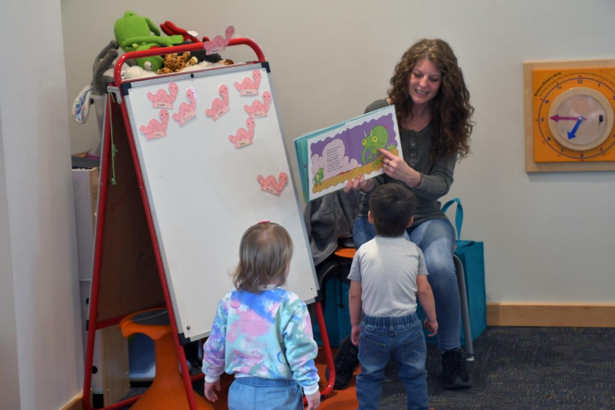 children enjoy story read by library staff