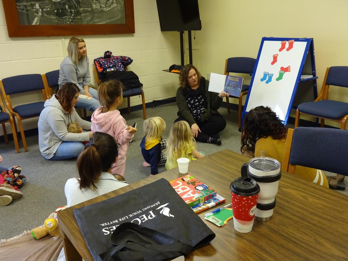 children enjoy story read by library staff